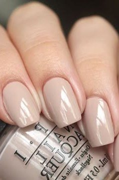 Taupe nude nails with OPI polish bottle