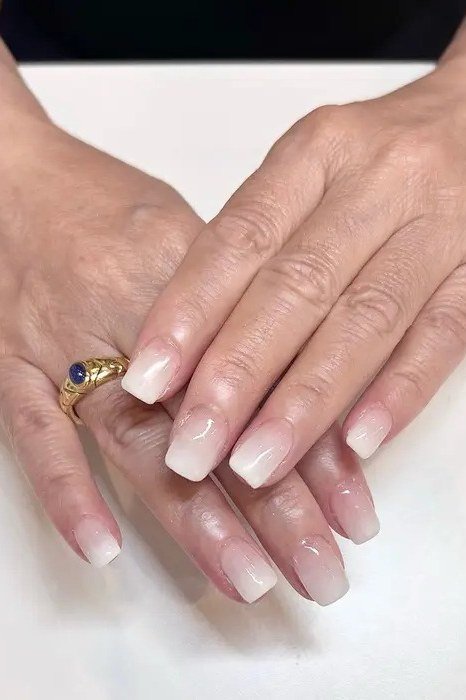 White to pink ombre on mature hands, medium nails, glossy, ombre nail design for women over 60