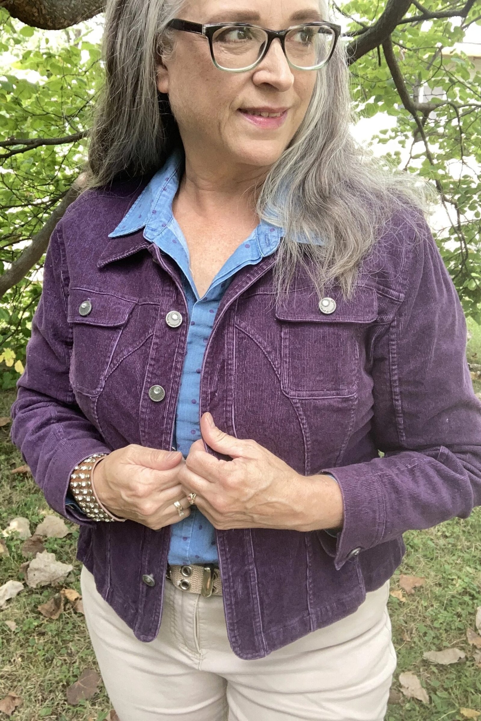 Purple corduroy shacket over chambray shirt with white jeans
