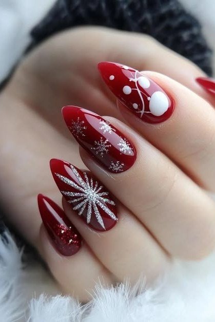 red christmas nails with white snowburst nail art