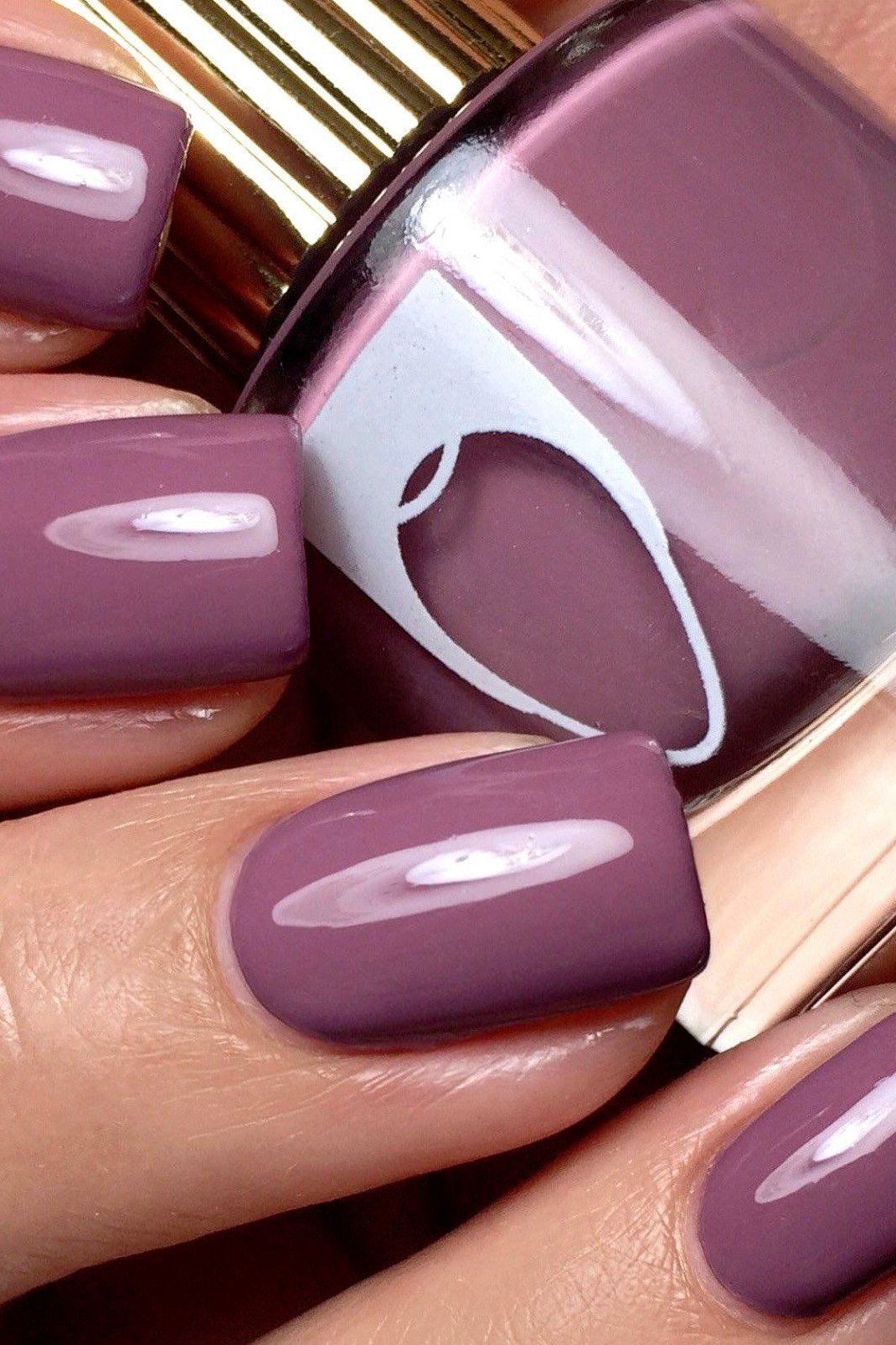 Mauve purple short nails with polish bottle, best manicure idea for women over 60