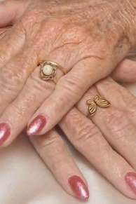 Nail art design for women over 60: pink chrome nails on older hands