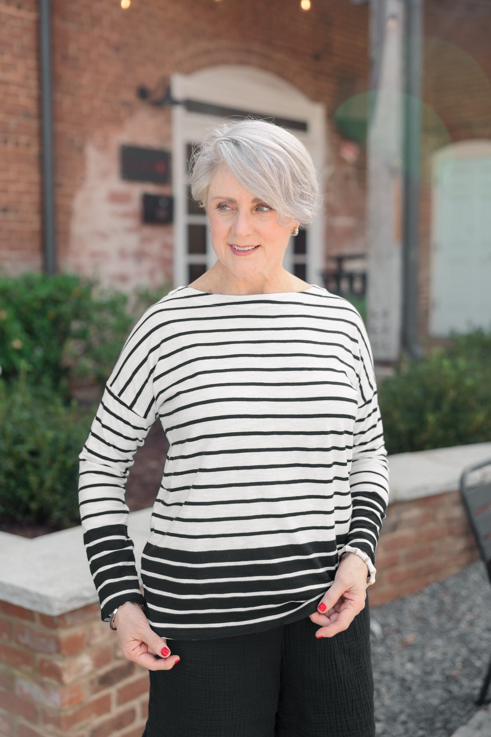 Woman over 50 wearing striped boatneck with black pants, everyday casual outfit idea