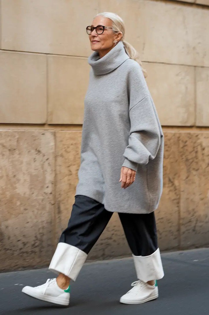 Gray turtleneck sweater with black trousers and white sneakers, casual fall outfit for women over 50