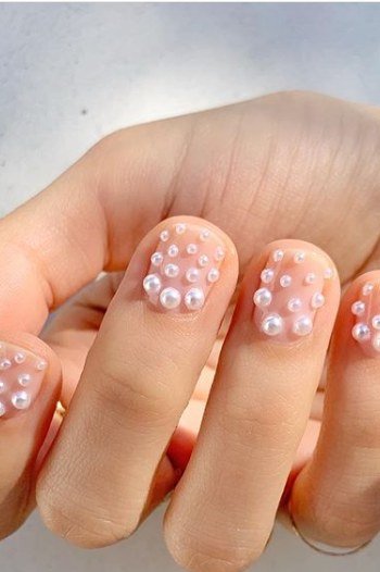 White nails with pearl daisy art for older women