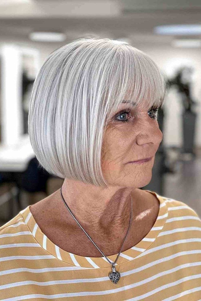 Crisp white french bob with straight fringe in salon