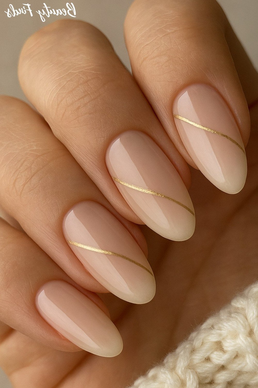 Nude almond nails with thin gold line, sophisticated nail design for women over 50