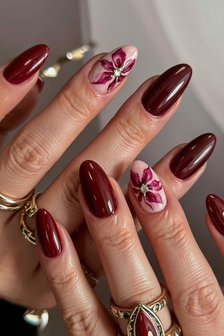 Burgundy almond nails with pink floral accent for women over 50