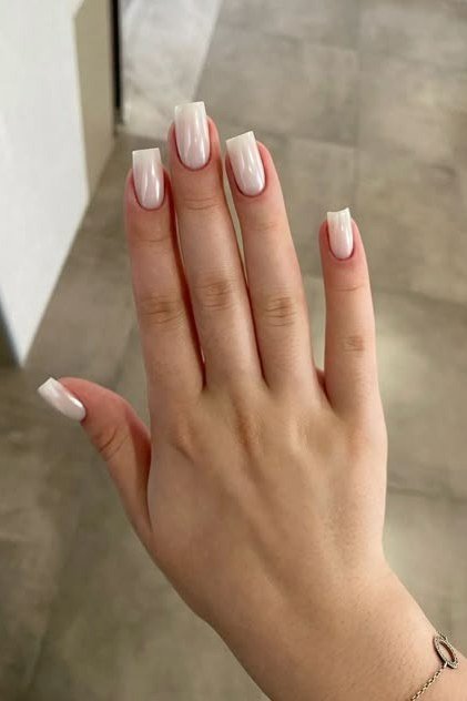Short natural nails in sheer milky white in daylight