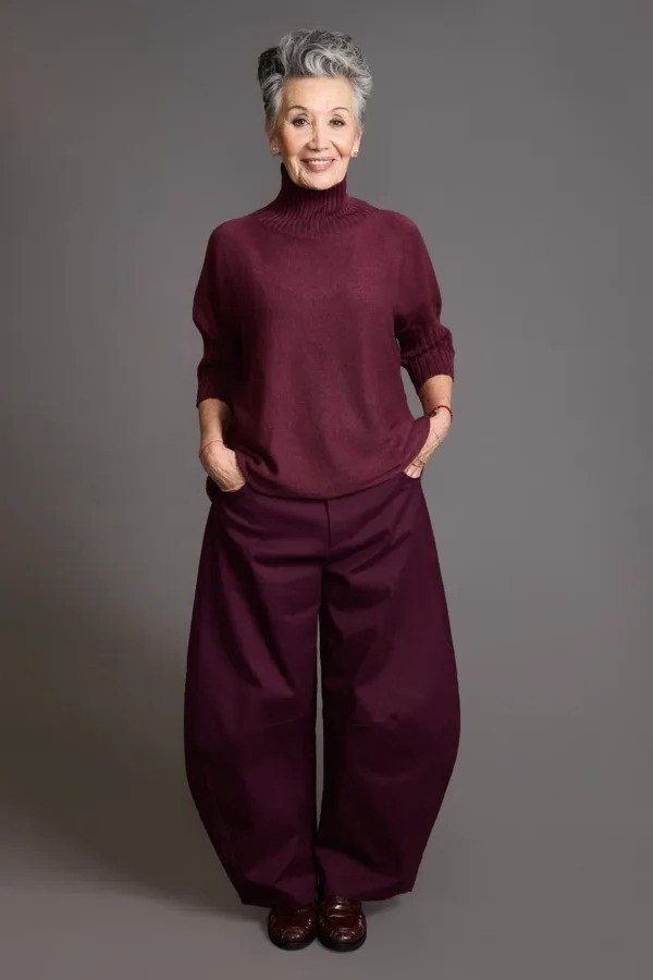 older woman in burgundy turtleneck and burgundy wide pants, monochrome fall look