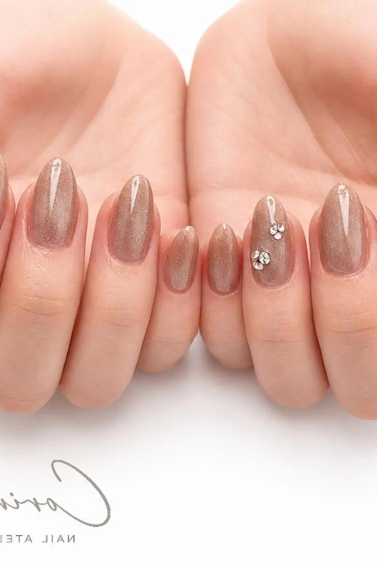taupe cat eye nails with crystal accents