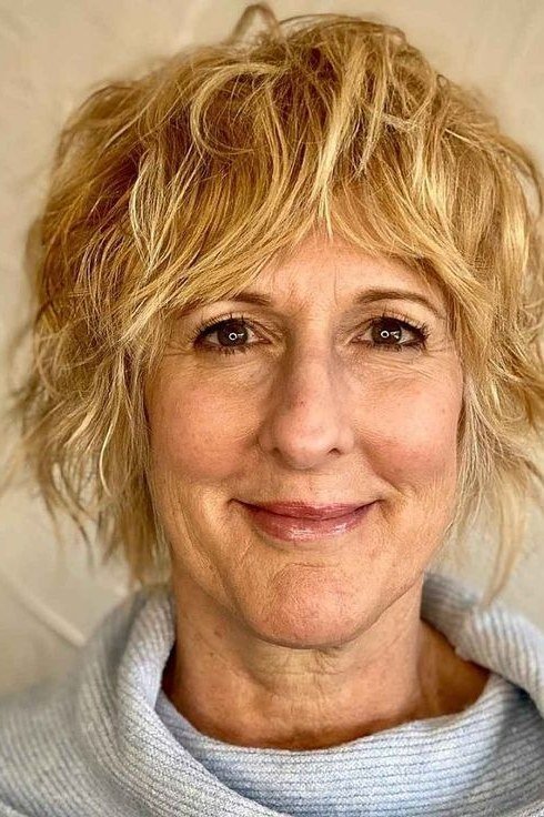 honey-blonde shaggy pixie, smiling front view hairstyle for women over 70
