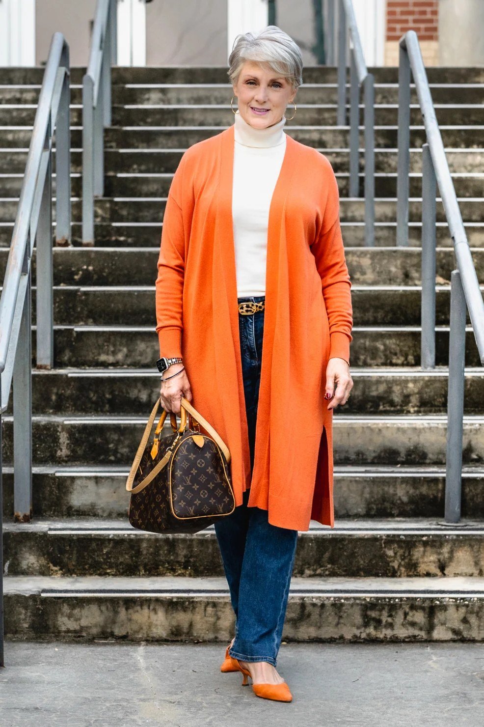 Burnt orange long cardigan with a white tee and blue jeans, vibrant weekend outfit for women over 40