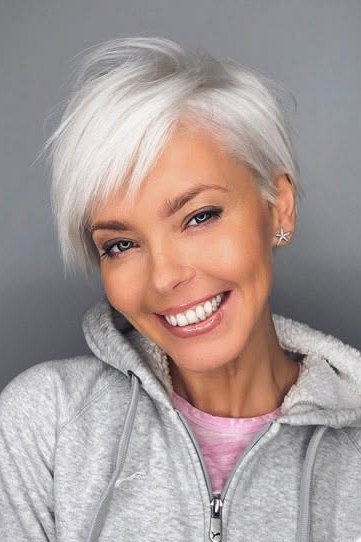 Short silver pixie, front view, smiling - wispy hairstyle for women over 40