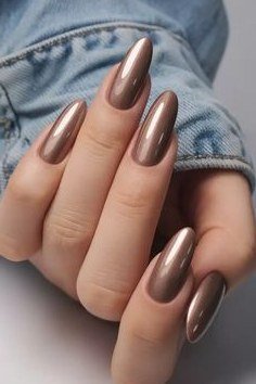 Bronze chrome metallic, almond shape, medium length, hand in denim jacket cuff, fall nail color for women over 40