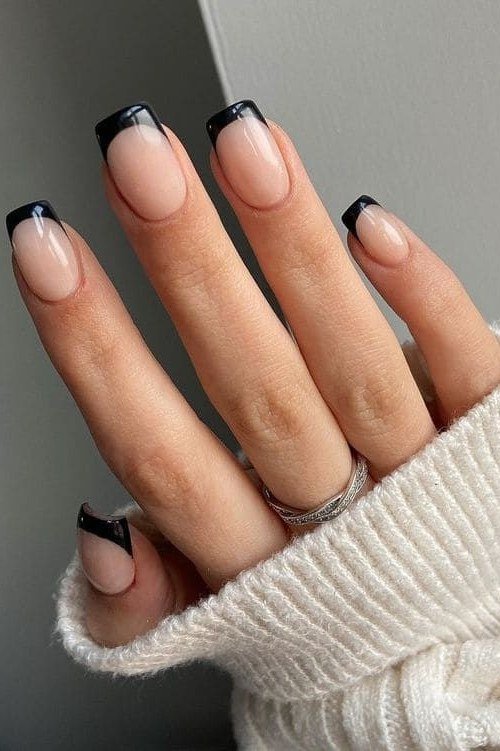 short squoval, black french tips, hand in cream knit sleeve , for women over 60