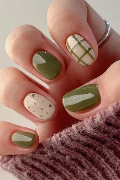 Olive green gel nails with plaid art for mature hands