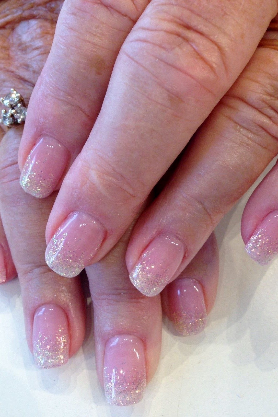 Best nails for women over 50: pink glitter ombre