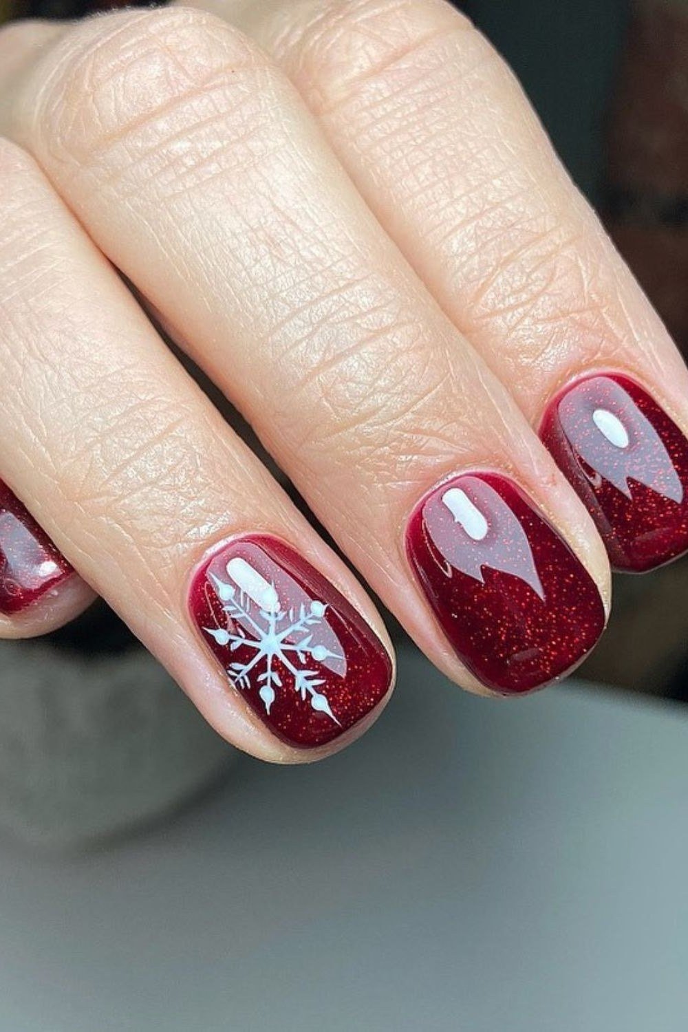 wine shimmer christmas nails with silver snowflake accent