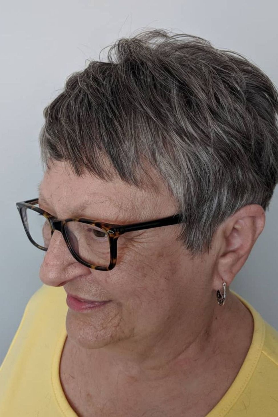 Silver pixie haircut for women over 70, three quarter view