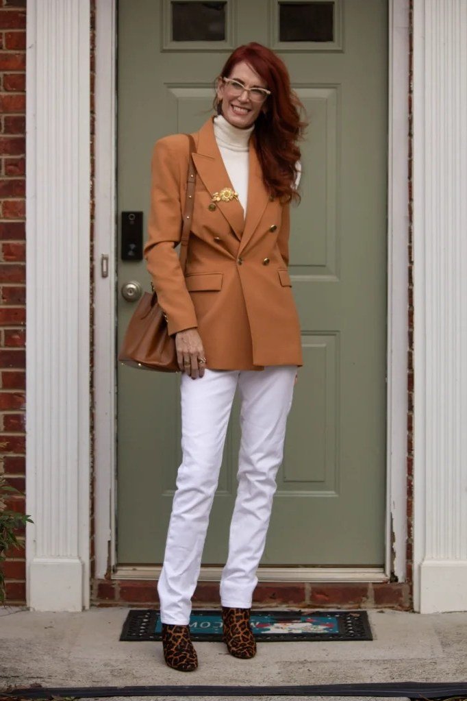 Rust blazer with white top and white jeans for women over 60