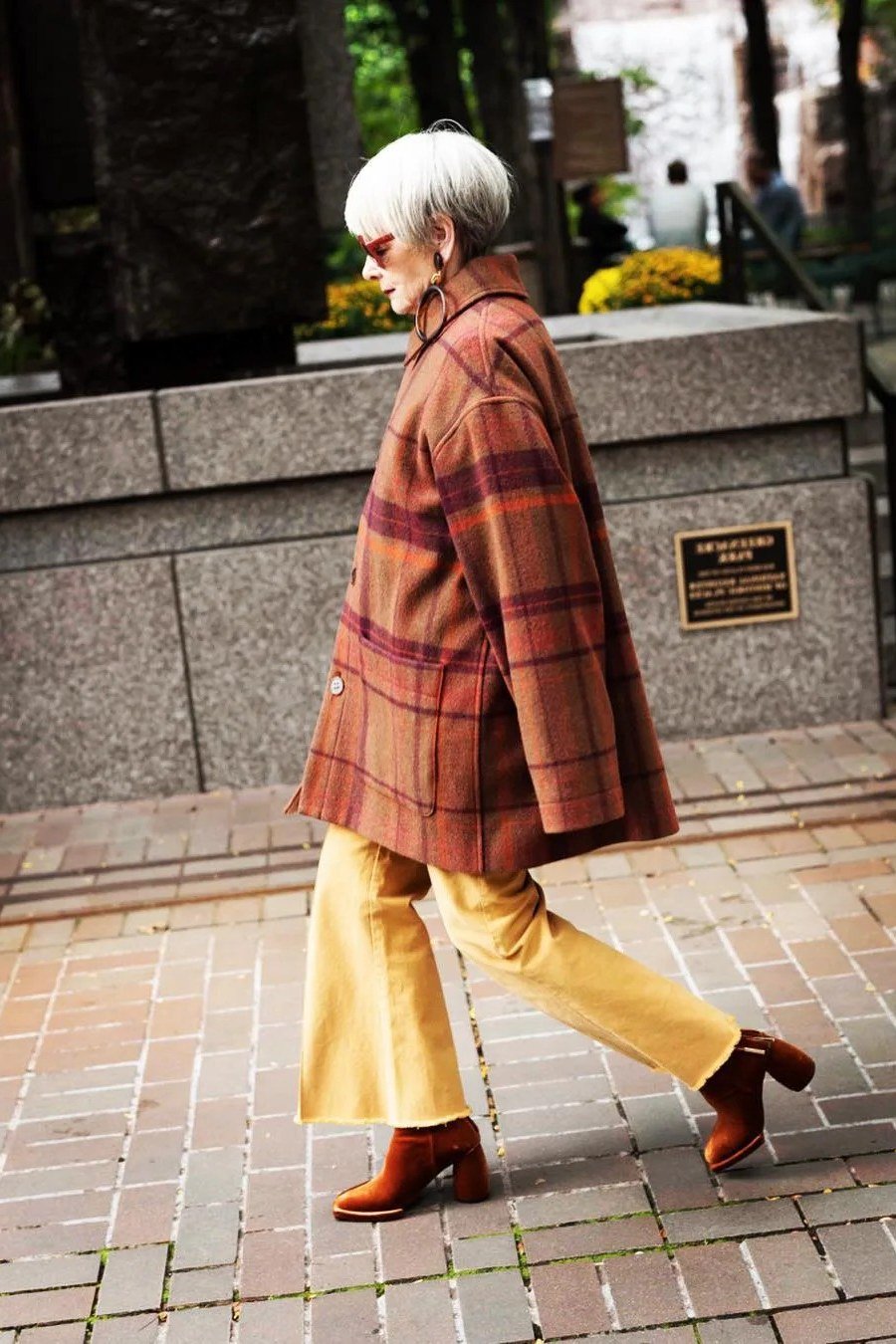 Fall city outfit for women over 50: rust plaid coat mustard wide leg trousers