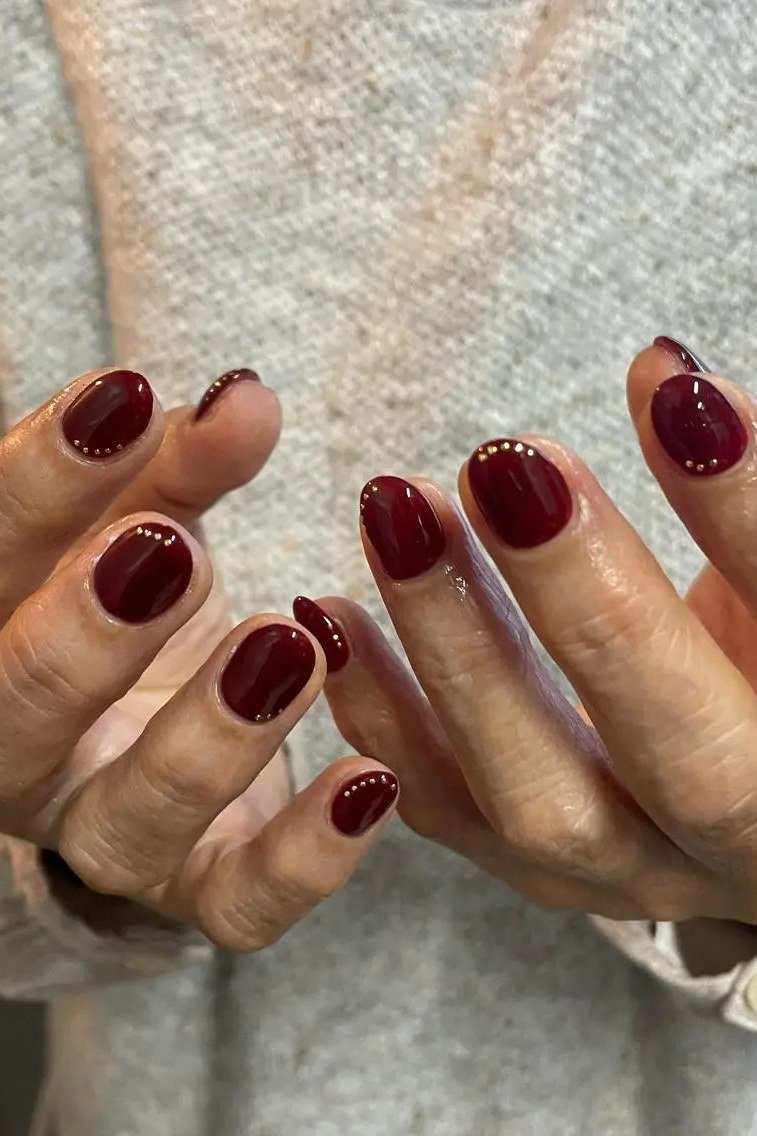 Oxblood Short Oval Nails with a Cream Sweater - old money fall nail color for women over 40
