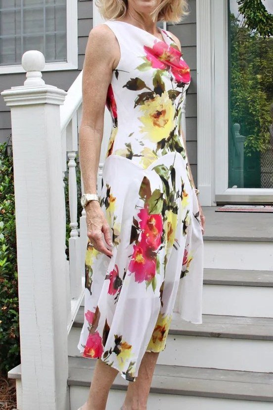 White maxi dress with bold red floral print for women over 60