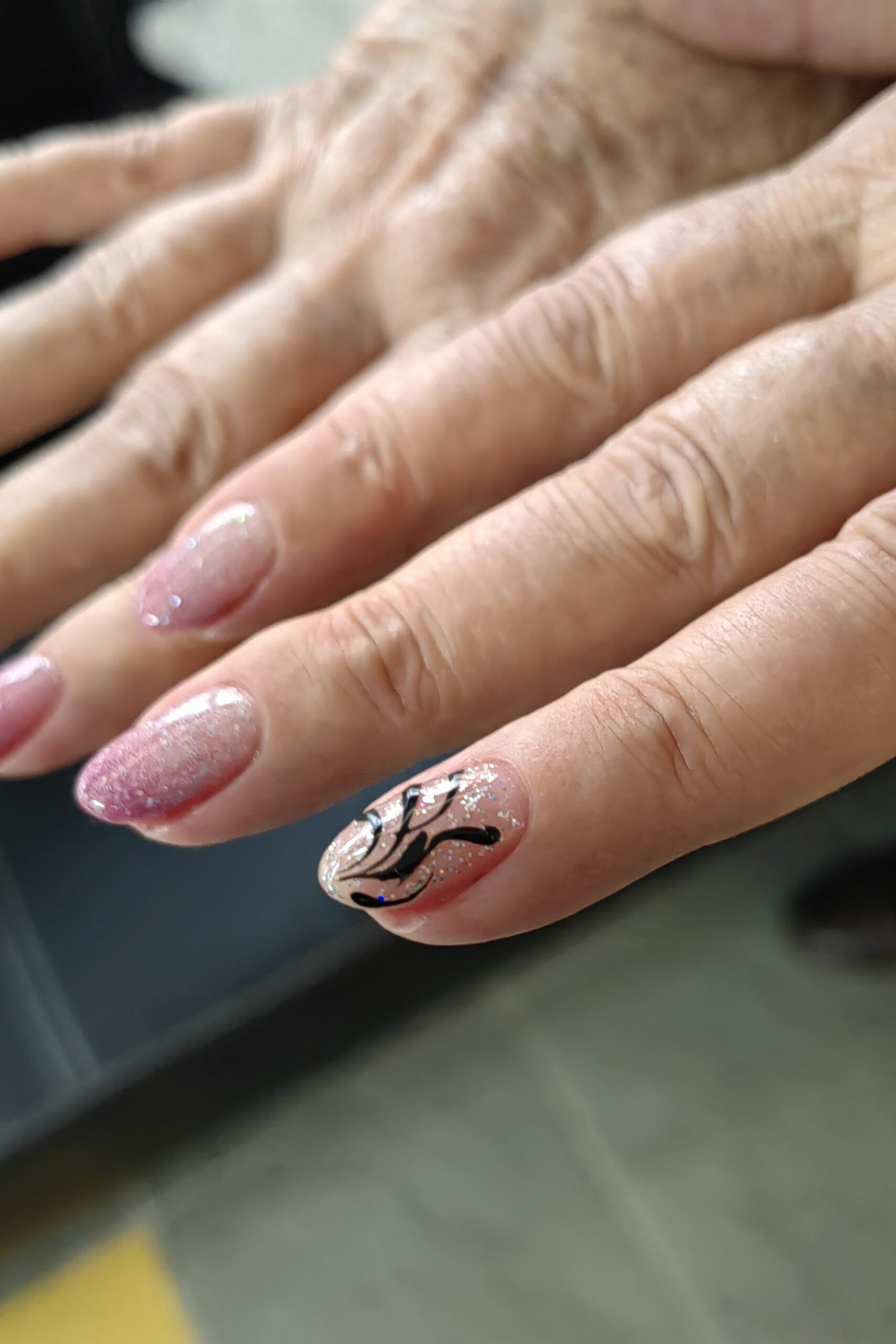 Mauve nails with black swirl line art