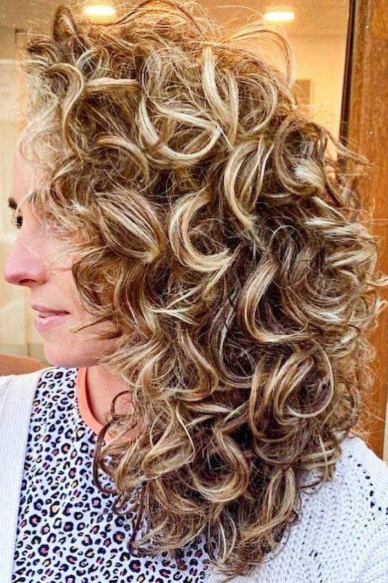 Long honey blonde curly layers for women over 50