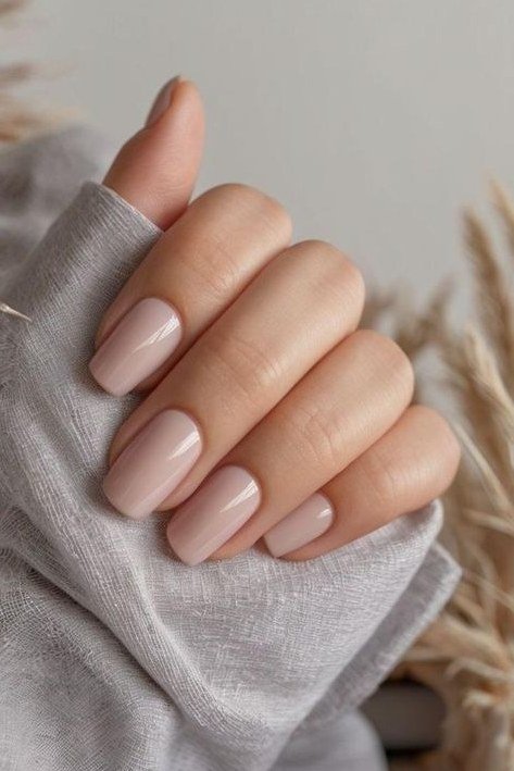 Nude nails with grey sweater sleeve
