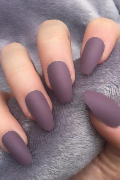 Soft Matte Mauve Almond Nails on Grey Fabric, elegant mauve nail idea for women over 60