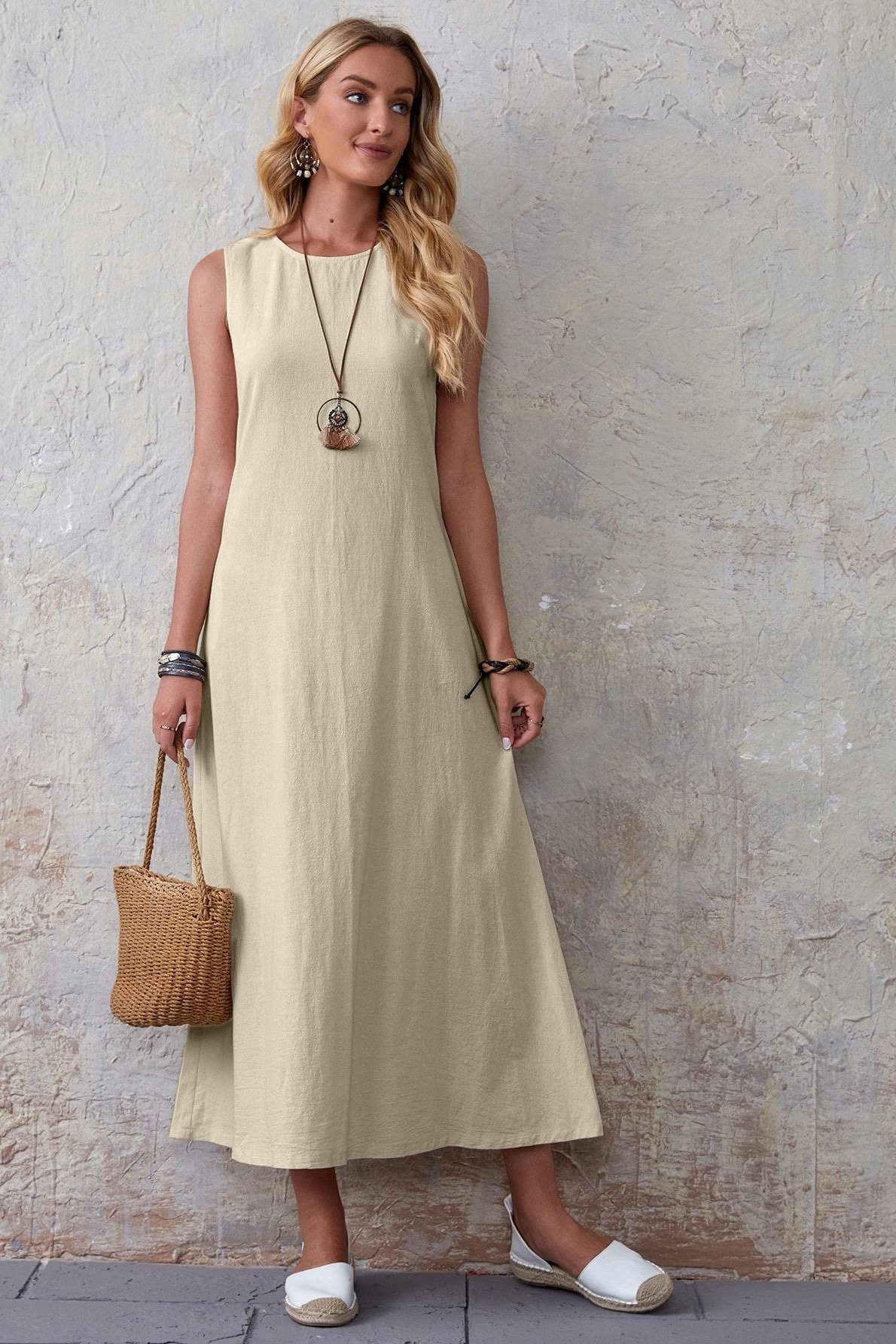 Butter-yellow maxi dress with pendant necklace and tan bag for women over 60