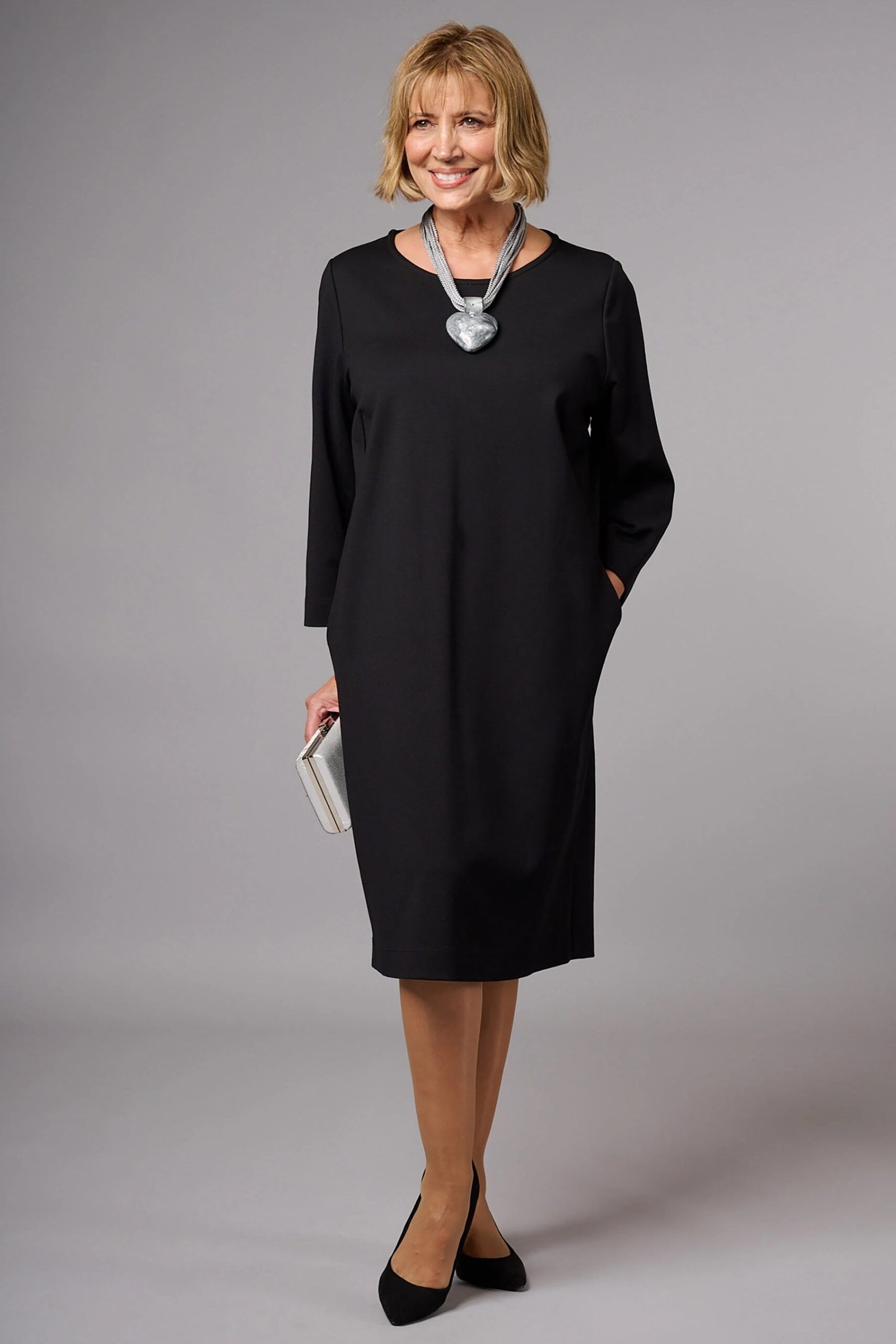 Black long-sleeve sheath dress for women over 50
