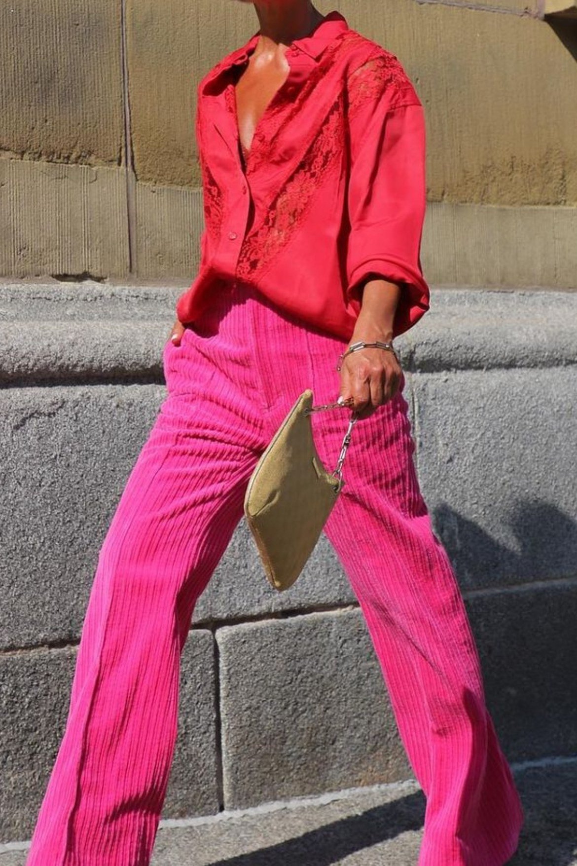 red silky blouse hot pink pleated wide trousers gold clutch women over 50