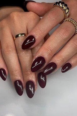 Deep Burgundy Almond Nails with Gold Rings - old money fall nail color for women over 40