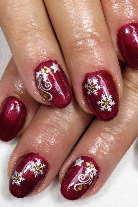 Mature hands, deep red nails with white snowflake art - classy Christmas nail idea for women over 70