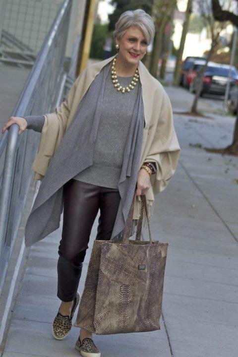 Elegant fall outfit for women over 70: cream shawl with gray top and leather-look pants