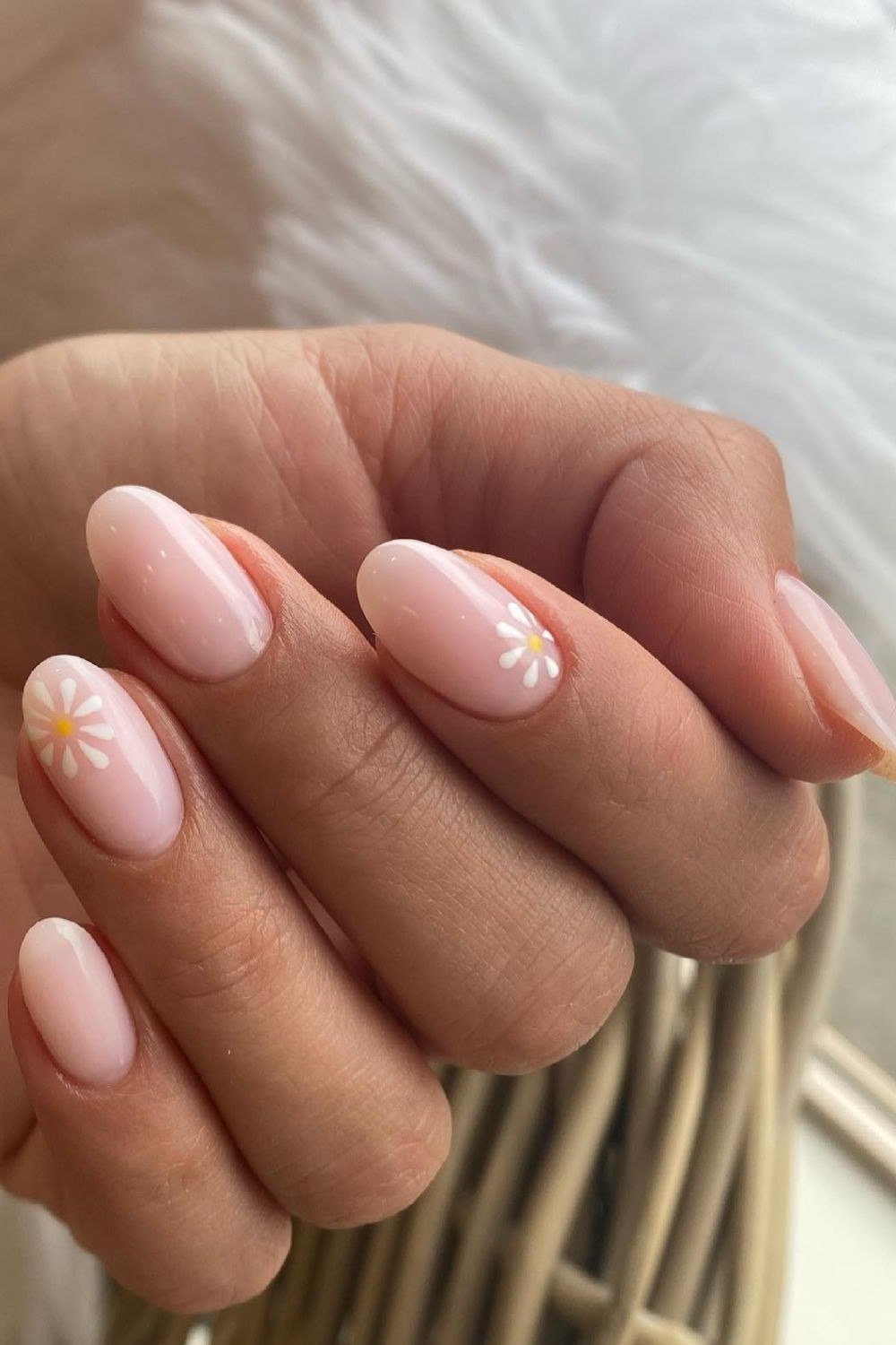Nude nails with white daisy accent nail art