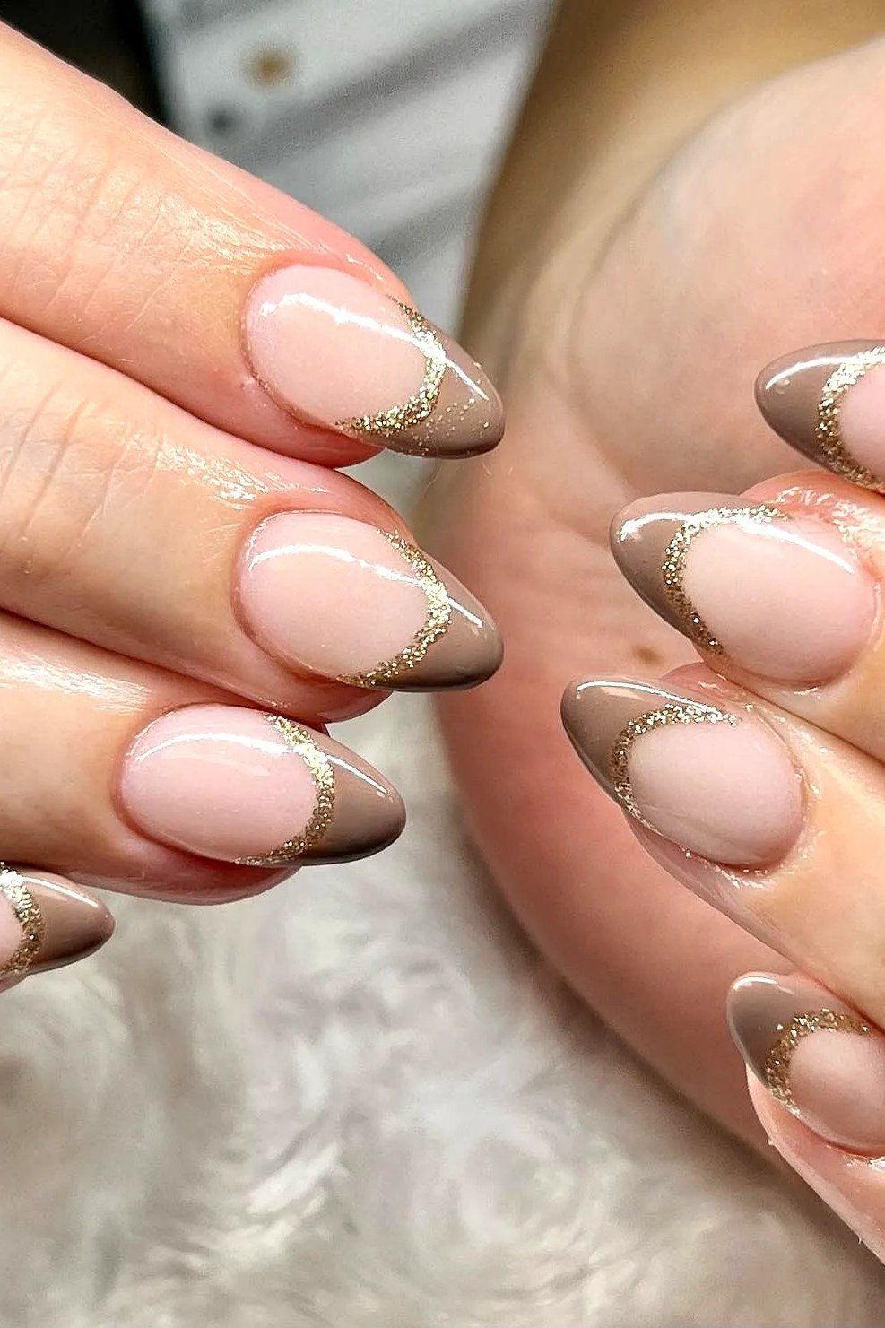 taupe french tip nails with gold glitter