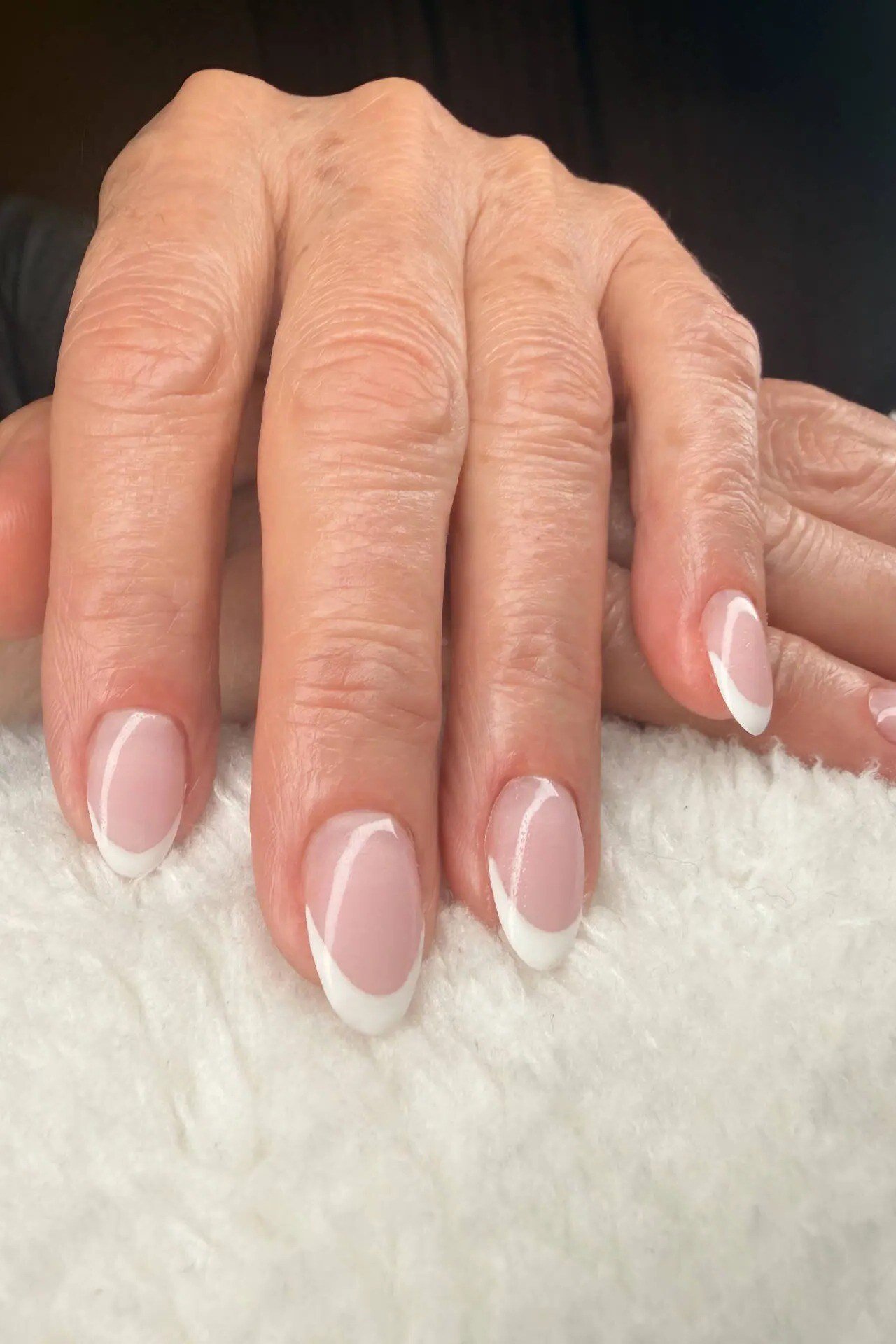 short squoval, pink gradient from clear to pink, one mature hand , for women over 60