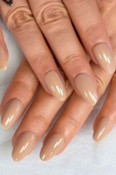 Tan nude almond nails on mature hands