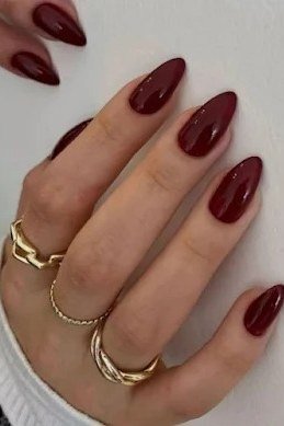 Oxblood Almond Nails with Stacked Gold Rings - old money fall nail color for women over 40