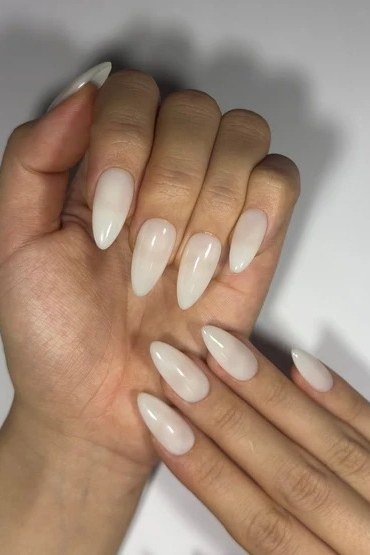 Milky white short nails on dark skin, both hands