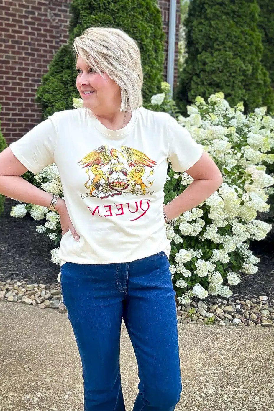 Woman over 50 wearing queen graphic tee with bright jeans, everyday casual outfit idea
