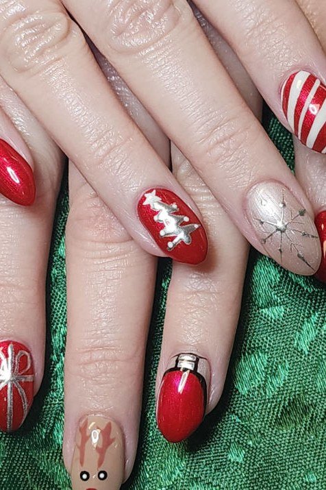 Candy cane stripes with reindeer and snowflake mix on red - Christmas nail design for older women