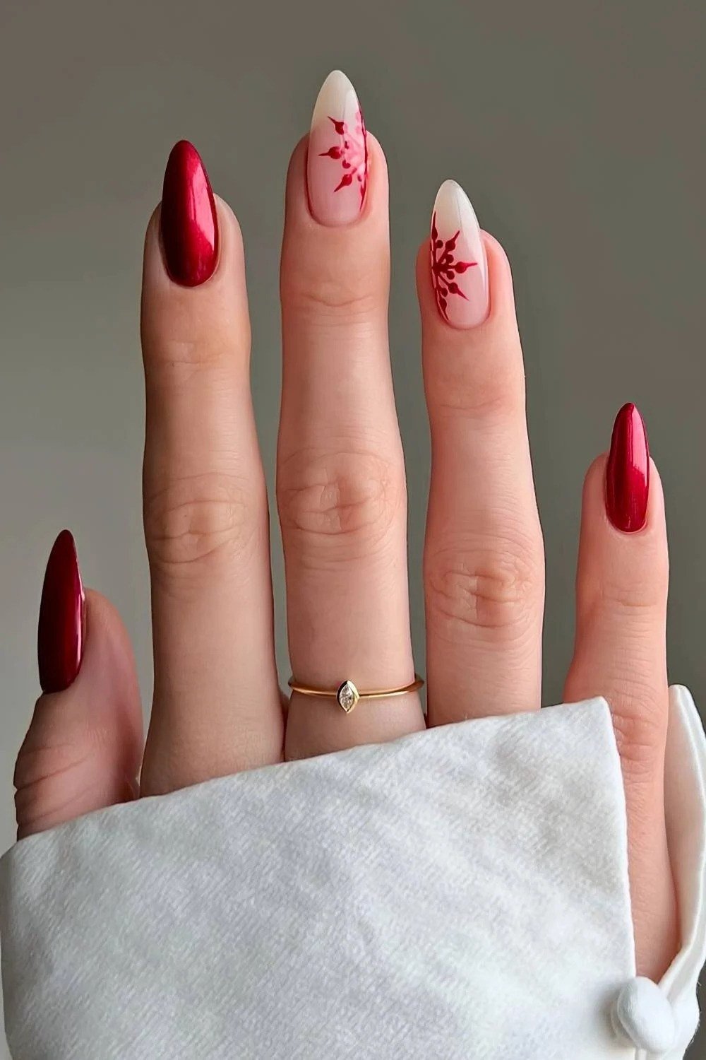 red almond christmas nails with white snowflakes