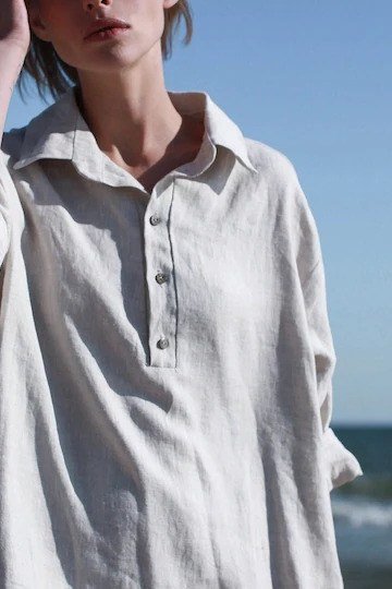 Oversized white linen shirt by the sea for women over 60