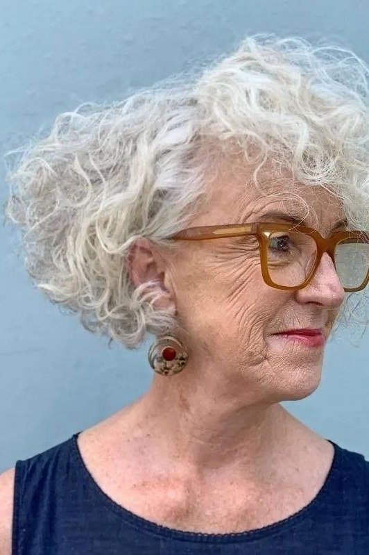 White curly bob front view with glasses - curly hairstyle for women over 60