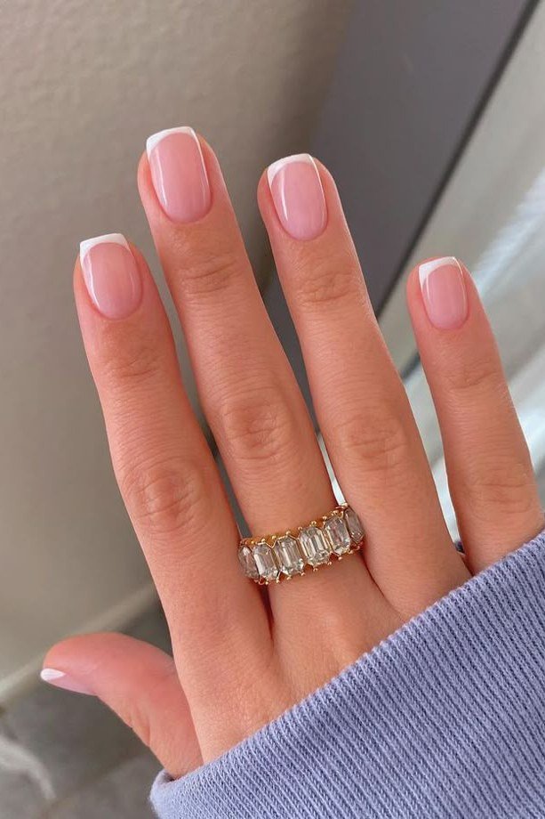 Pink french tip nails with sparkling diamond eternity ring